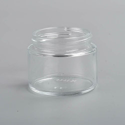2 ounce V2 flush mount, child-resistant packaging, transparent glass base, cylindrical design.