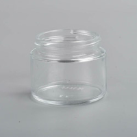 2 ounce V2 flush mount, child-resistant packaging, transparent glass base, cylindrical design.