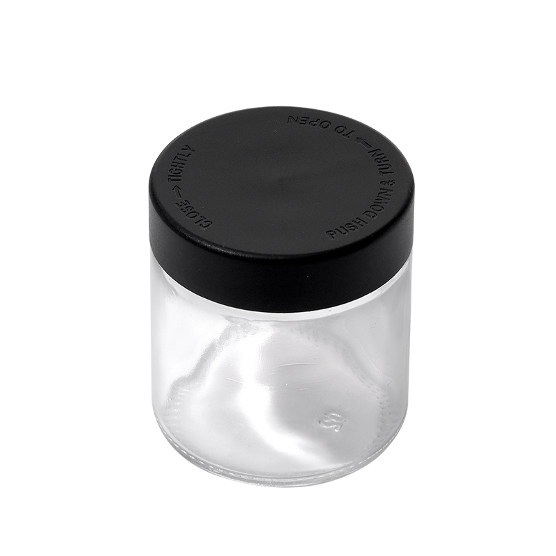 3 ounce V2 flush mount, child-resistant packaging, transparent glass base, cylindrical design.