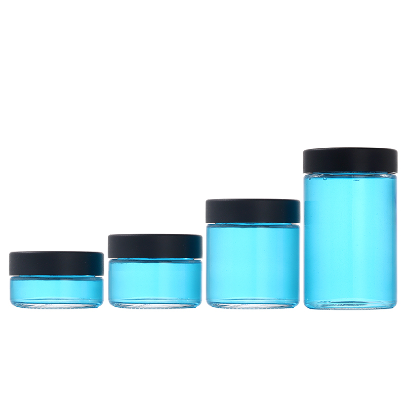 1 ounce V2 flush mount, child-resistant packaging, transparent glass base, cylindrical design.