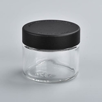 2 ounce V2 flush mount, child-resistant packaging, transparent glass base, cylindrical design.