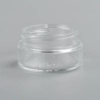 1 ounce V2 flush mount, child-resistant packaging, transparent glass base, cylindrical design.